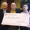 Jeremy Hogan | Herald-TimesMayer Maloney, publisher of The Herald-Times and Hoosier Times newspapers, presented a check to Innovation Prize winners, Murat Kacan, center, and Nick El Khoury at the University Club at the Indiana Memorial Union.